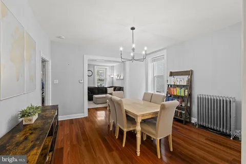a view of a dining room with furniture wooden floor and chandelier