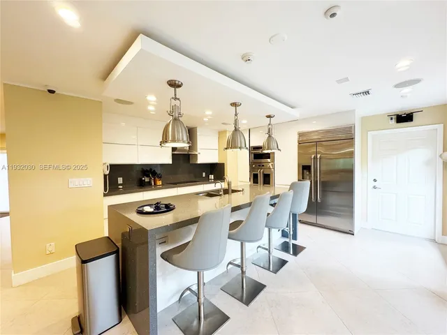 a kitchen with stainless steel appliances a stove a sink dishwasher and a refrigerator