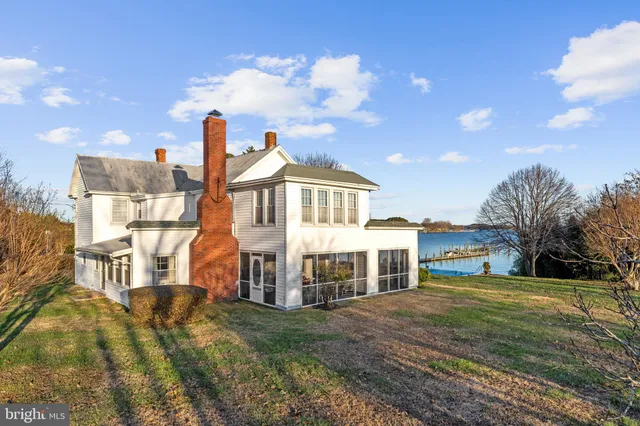a view of a dining room with furniture wooden floor and chandelier