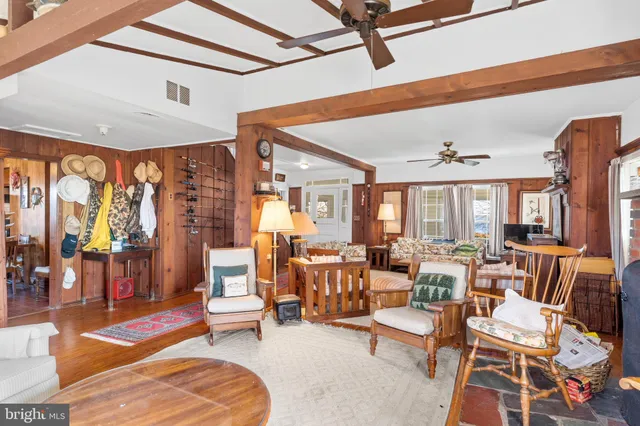 a dining room with furniture window and wooden floor