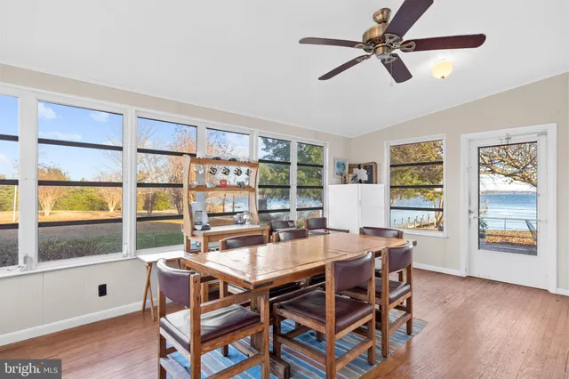 a kitchen with a table chairs sink and cabinets