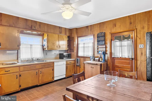 a kitchen with stainless steel appliances granite countertop a sink and cabinets