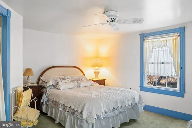 a bedroom with bed and window