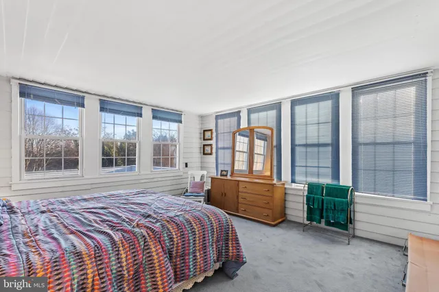a bedroom with furniture and window