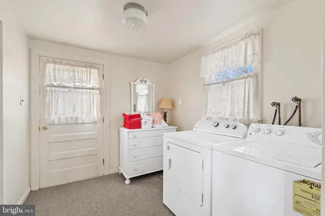 a bedroom with two beds and a window