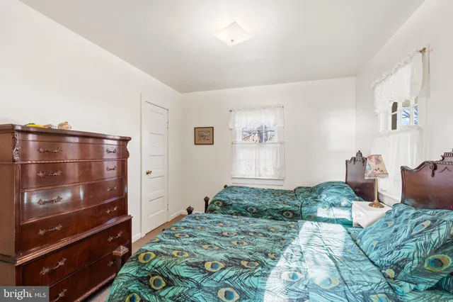 a bathroom with a sink toilet and a window