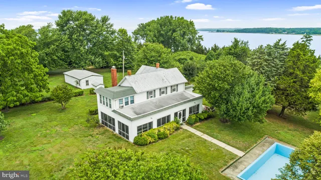 an aerial view of a house having yard table and chairs