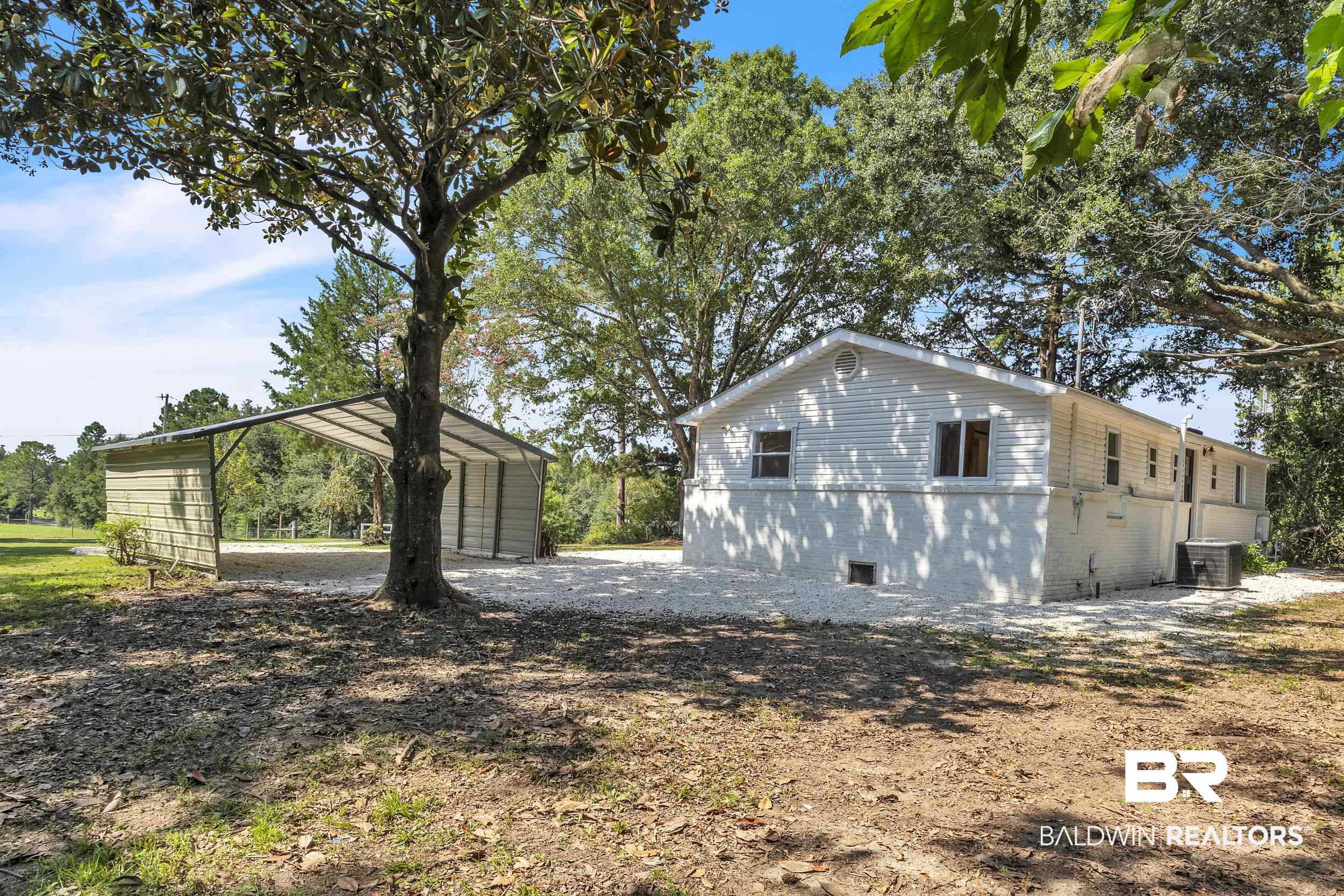 14001 Melvin Johnson Road Stapleton, AL 36578 - Photo 26 of 31 View of property exterior featuring a detached carport and a central AC unit