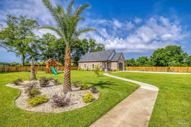 a view of yard with swimming pool and green space