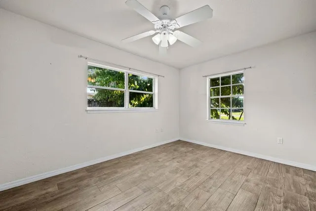 a view of an empty room with wooden floor