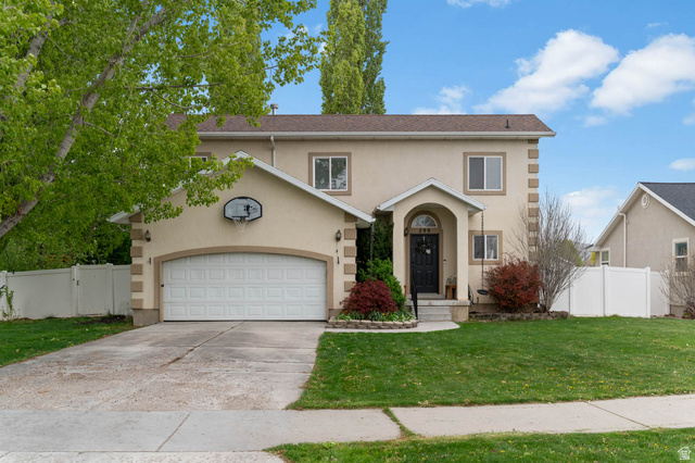 299 West 1500th Street South Payson, UT 84651 - Photo 1 of 1 Traditional-style home with stucco siding, driveway, a garage, and a gate