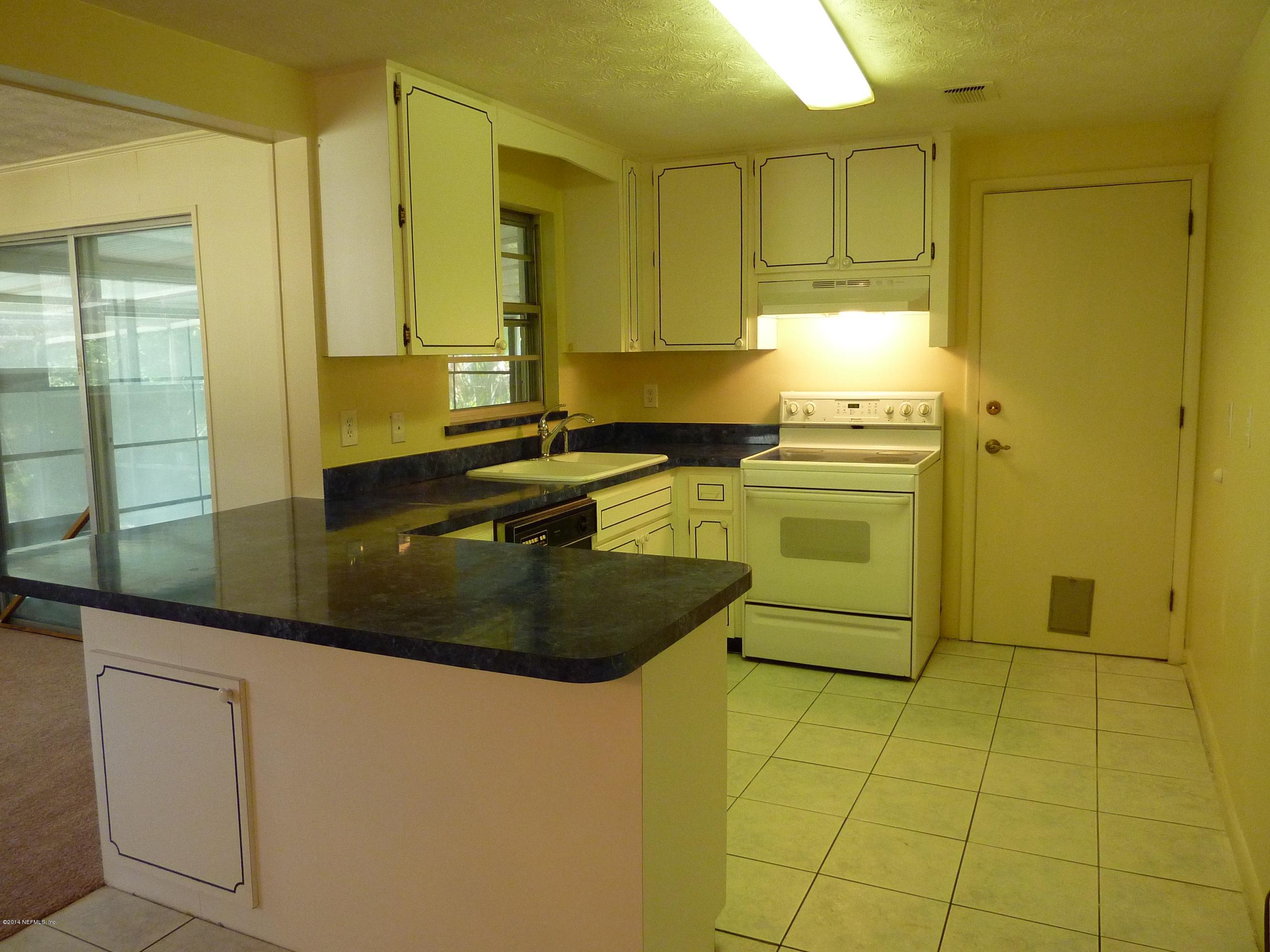14545 Stacey Road Jacksonville, FL 32250 - Photo 6 of 12 a kitchen with a sink and cabinets