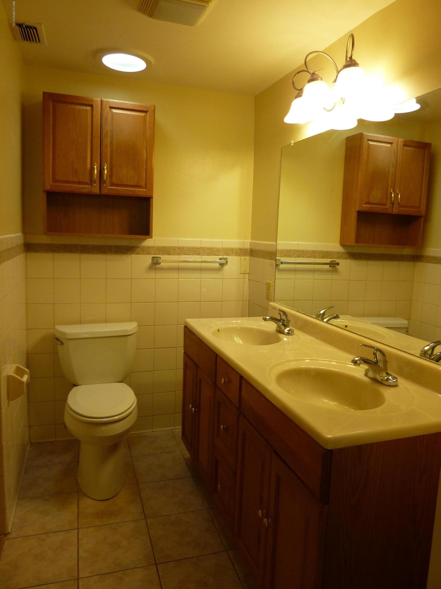 14545 Stacey Road Jacksonville, FL 32250 - Photo 7 of 12 a bathroom with a sink and a toilet
