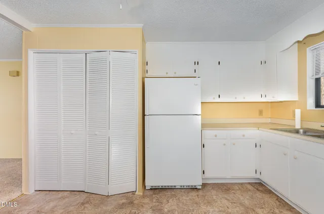 an empty room with a ceiling fan and a window