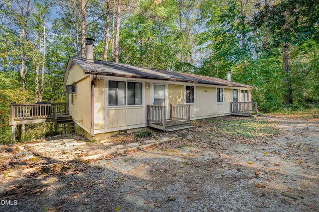a view of a wooden house with a yard