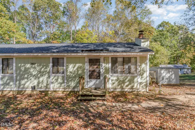 a view of a wooden door with a wooden fence