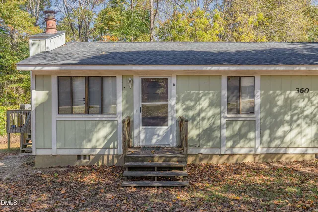 a view of a small house with a yard