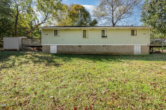 a view of a yard with plants and trees