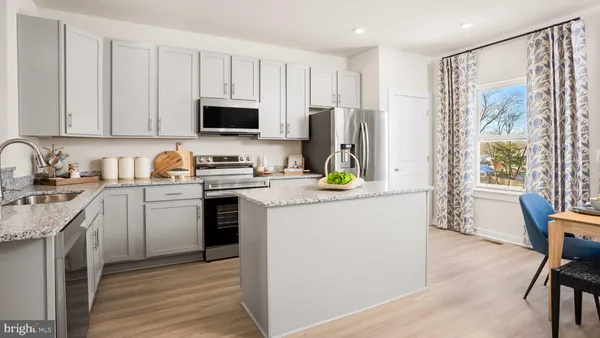 a kitchen with stainless steel appliances a stove refrigerator sink and cabinets