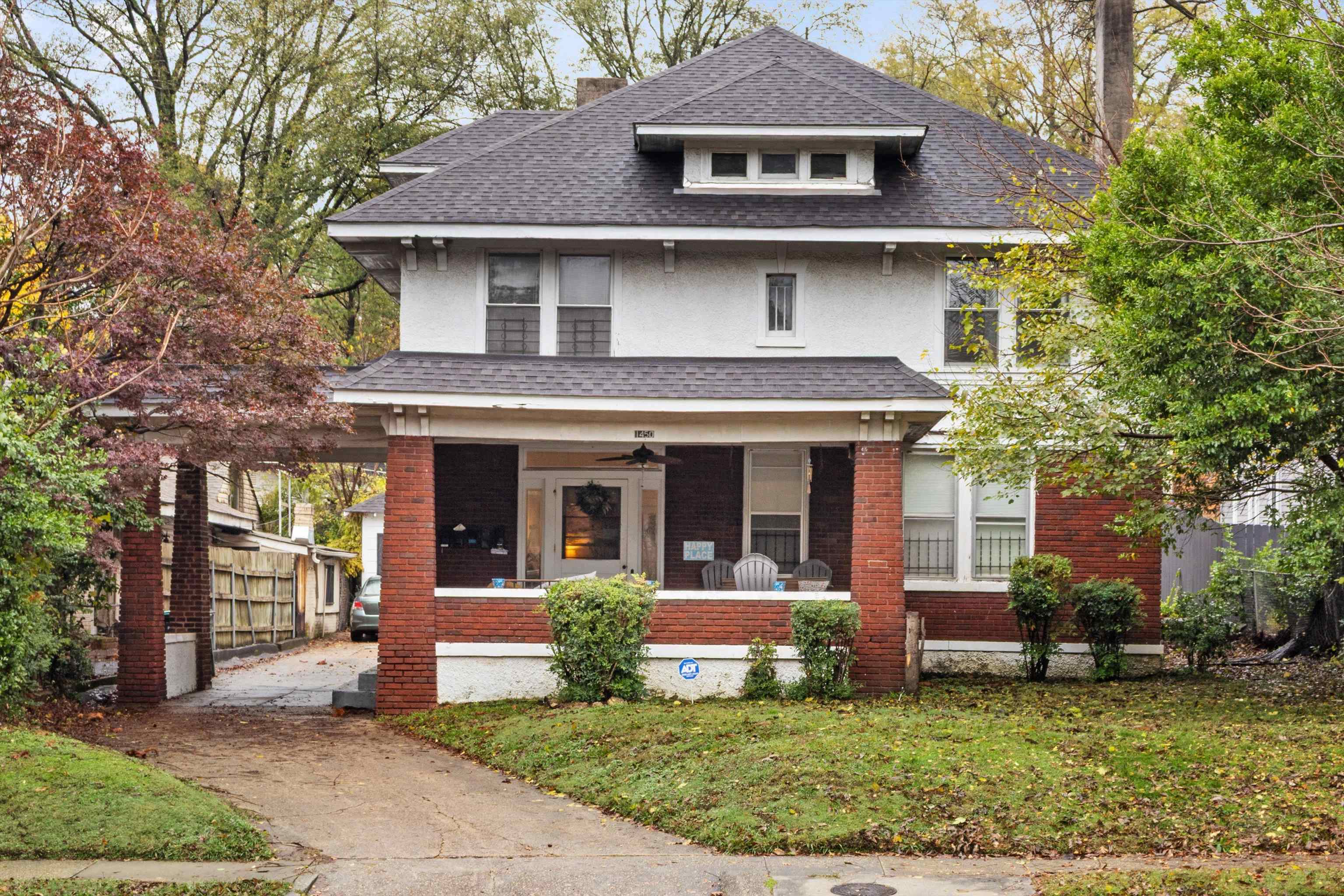 a view of a white house with large windows and a yard