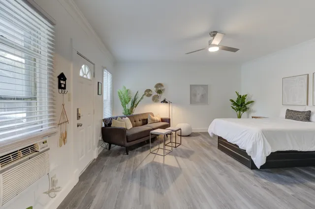 a living room with furniture and wooden floor