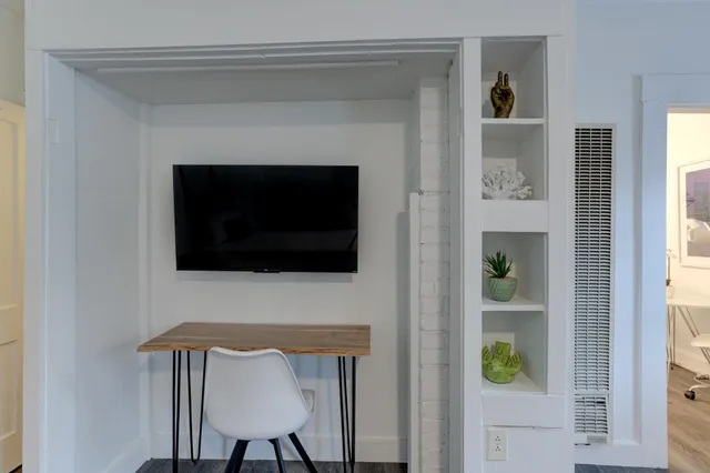 a living room with a fireplace and a flat screen tv
