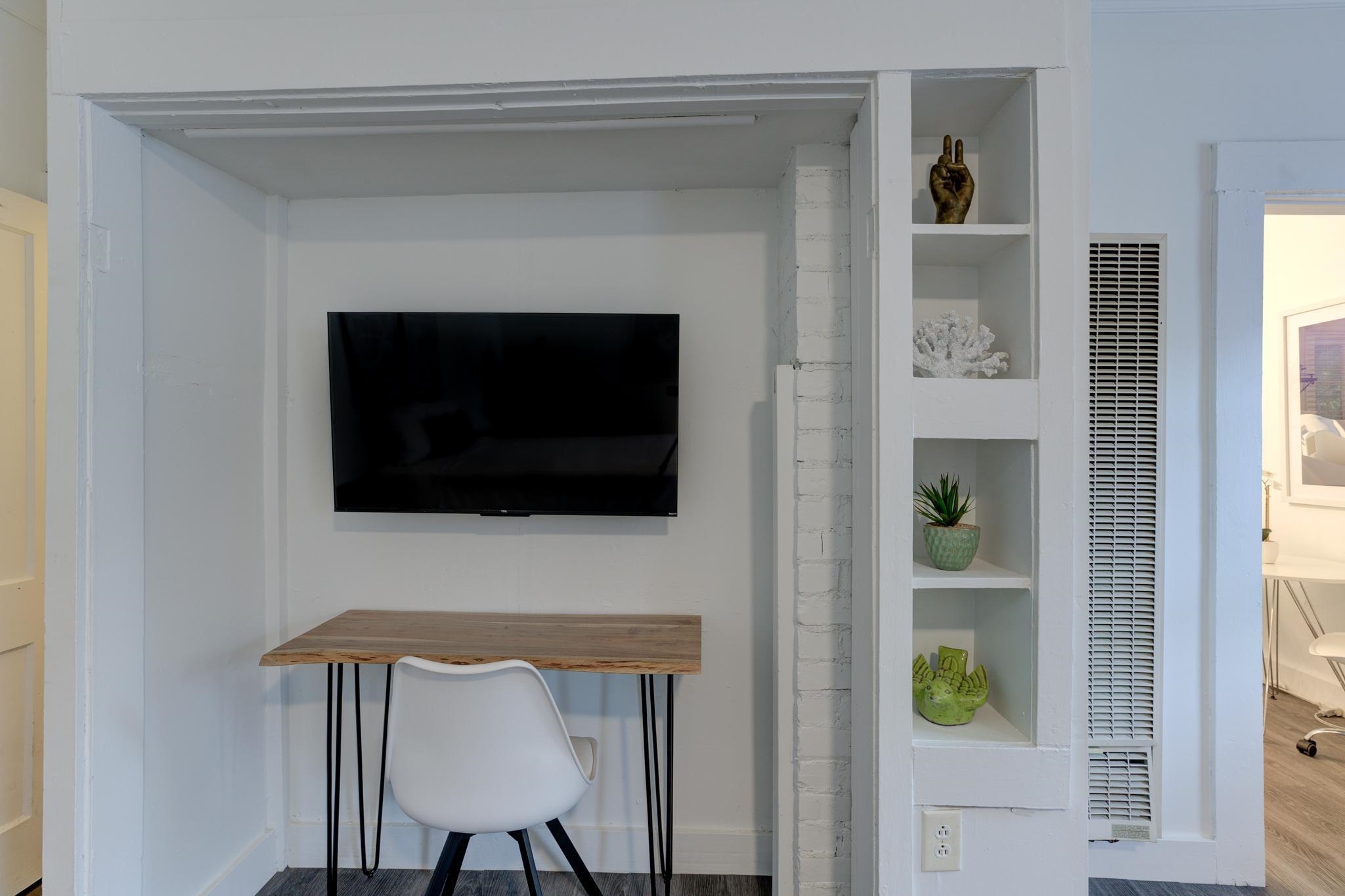 1450 Peabody Avenue Memphis, TN 38104 - Photo 6 of 10 a living room with a fireplace and a flat screen tv