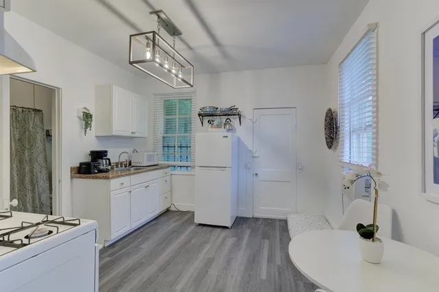a kitchen with a sink stainless steel appliances and cabinets