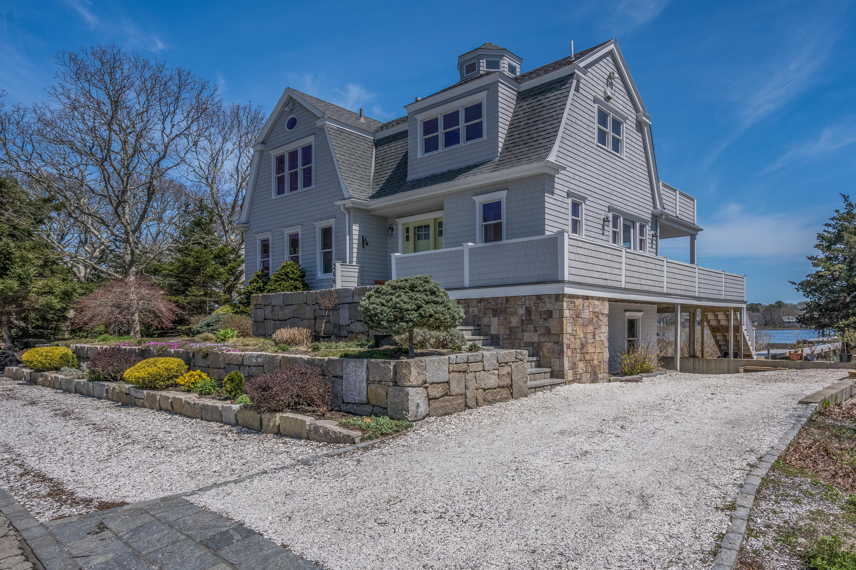 266 Monomoscoy Road Mashpee, MA 02649 - Photo 3 of 35 a front view of a house with swimming pool and sitting area
