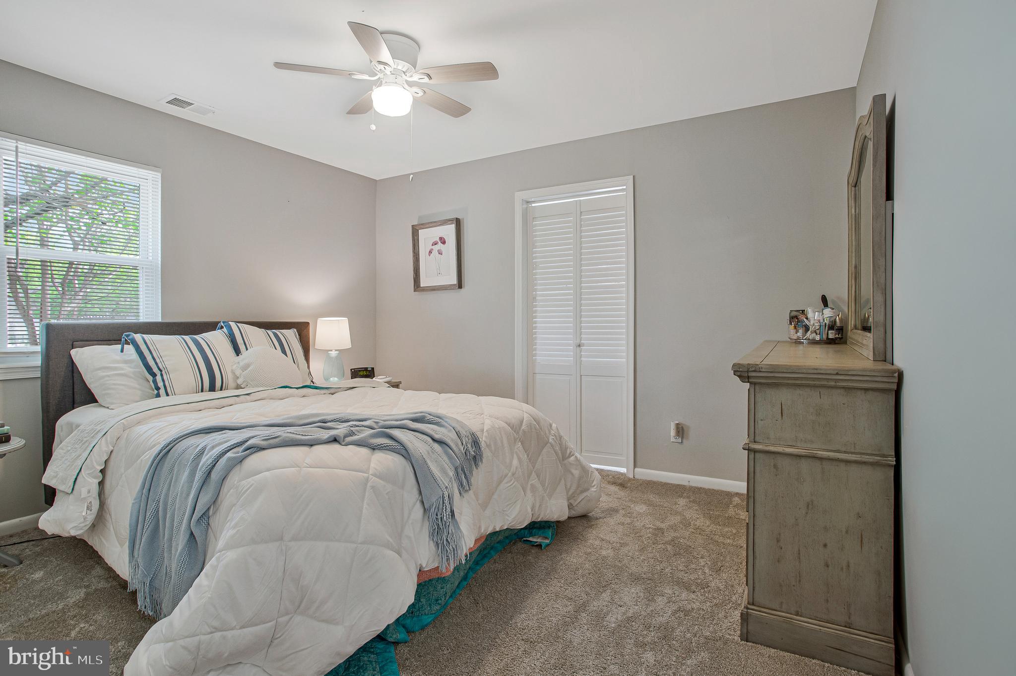 114 River Road Edgewater, MD 21037 - Photo 18 of 30 a bedroom with a bed and a chandelier