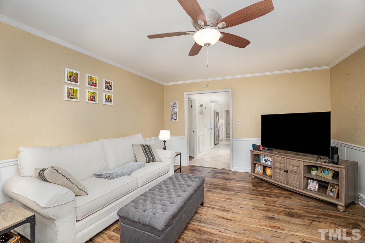 2009 Ryerson Drive Garner, NC 27529 - Photo 11 of 27 a living room with furniture and a flat screen tv