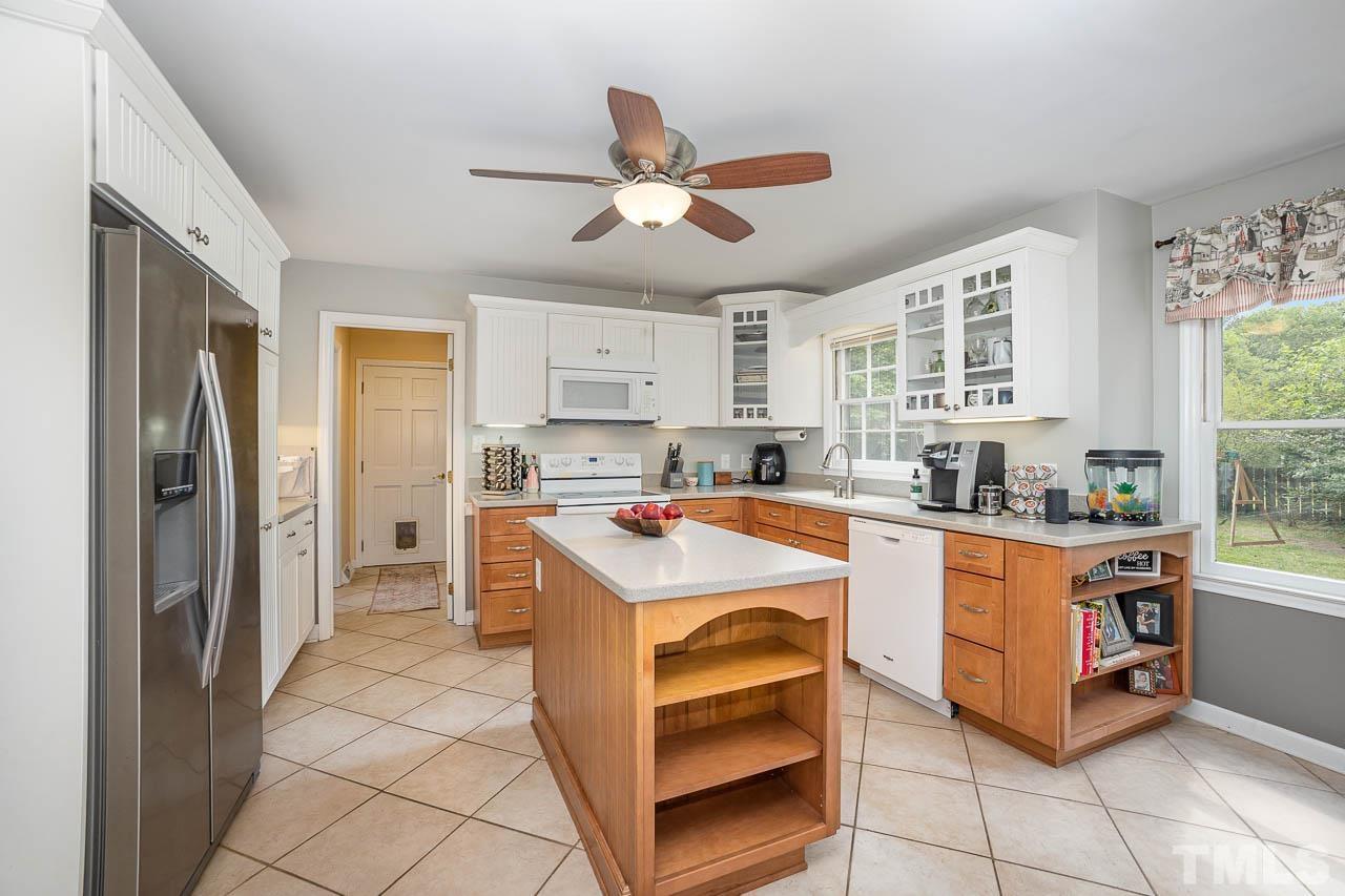 2009 Ryerson Drive Garner, NC 27529 - Photo 12 of 27 a kitchen with stainless steel appliances granite countertop a refrigerator a sink a stove and white cabinets