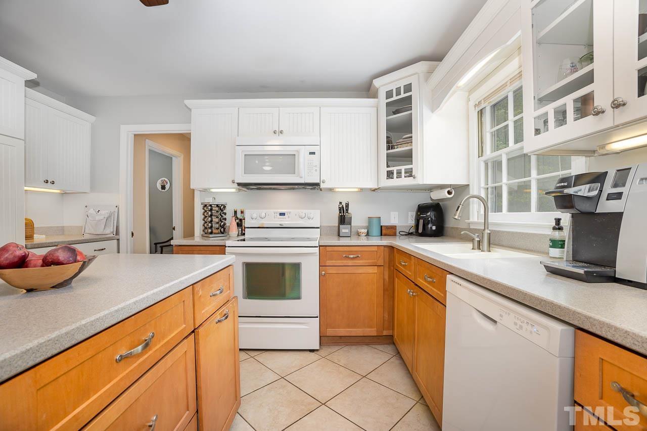 2009 Ryerson Drive Garner, NC 27529 - Photo 13 of 27 a kitchen with stainless steel appliances a sink stove and cabinets