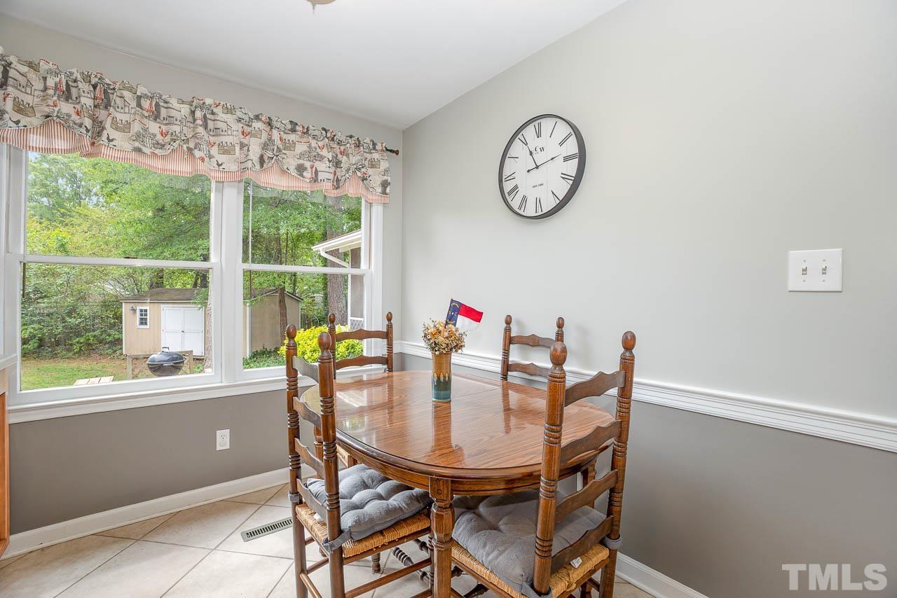 2009 Ryerson Drive Garner, NC 27529 - Photo 15 of 27 a dining room with furniture and a large window