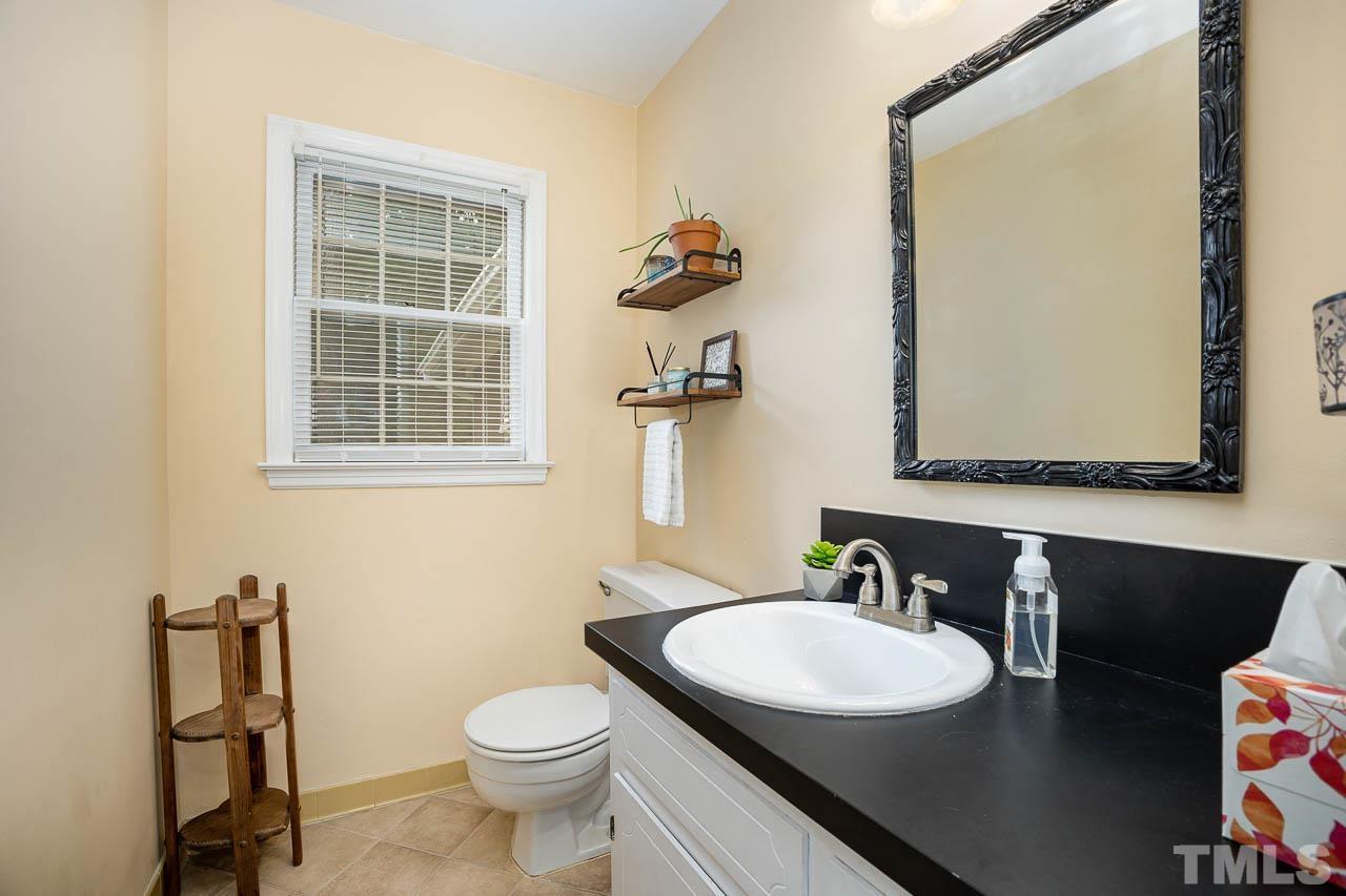 2009 Ryerson Drive Garner, NC 27529 - Photo 19 of 27 a bathroom with a toilet a sink and mirror