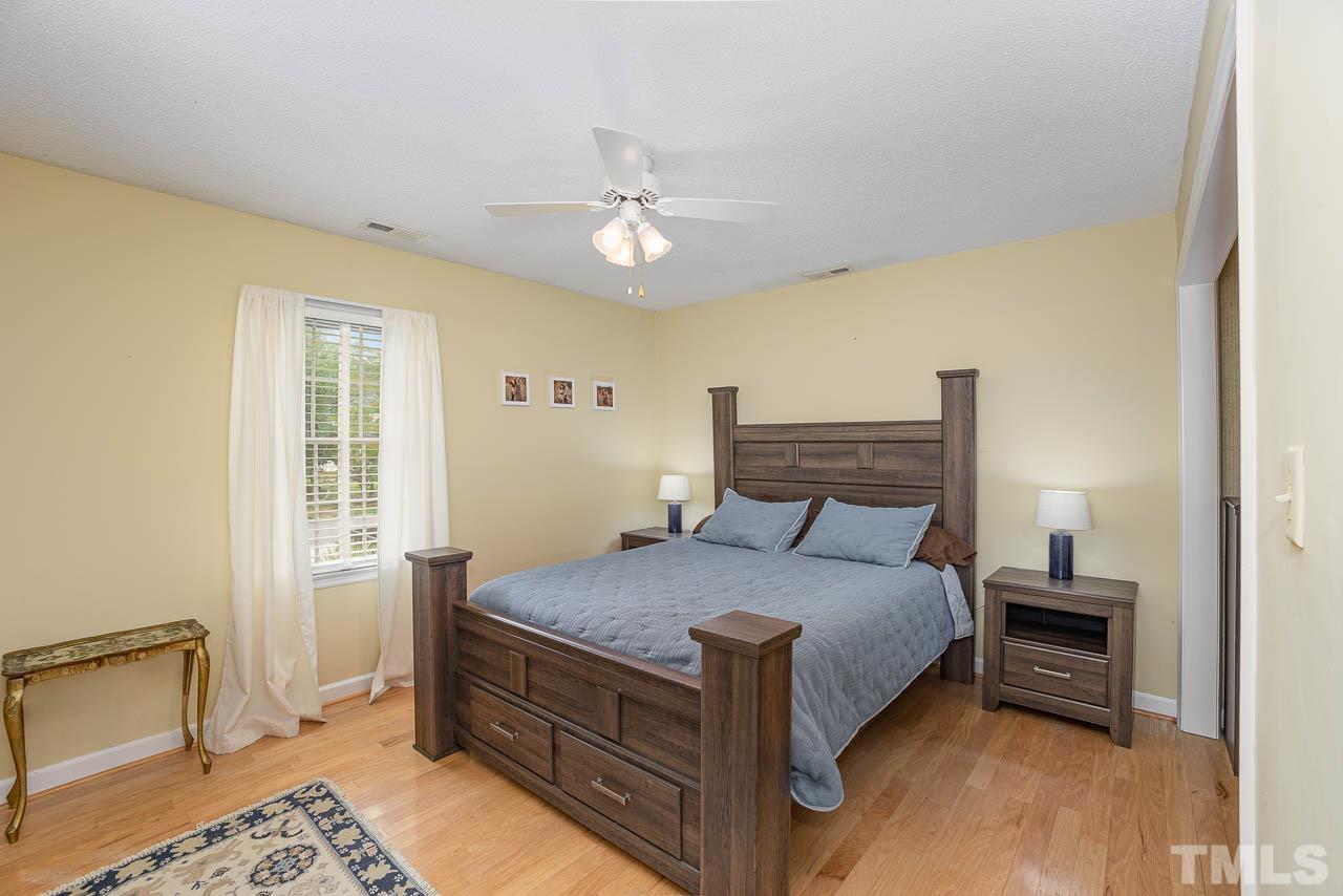 2009 Ryerson Drive Garner, NC 27529 - Photo 20 of 27 a bedroom with a bed and a dresser with wooden floor