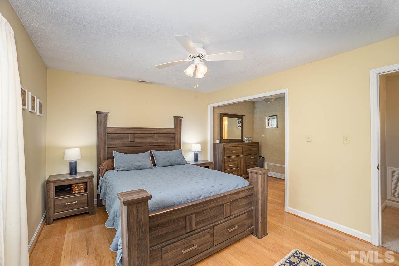 2009 Ryerson Drive Garner, NC 27529 - Photo 21 of 27 a bedroom with a bed and wooden floor