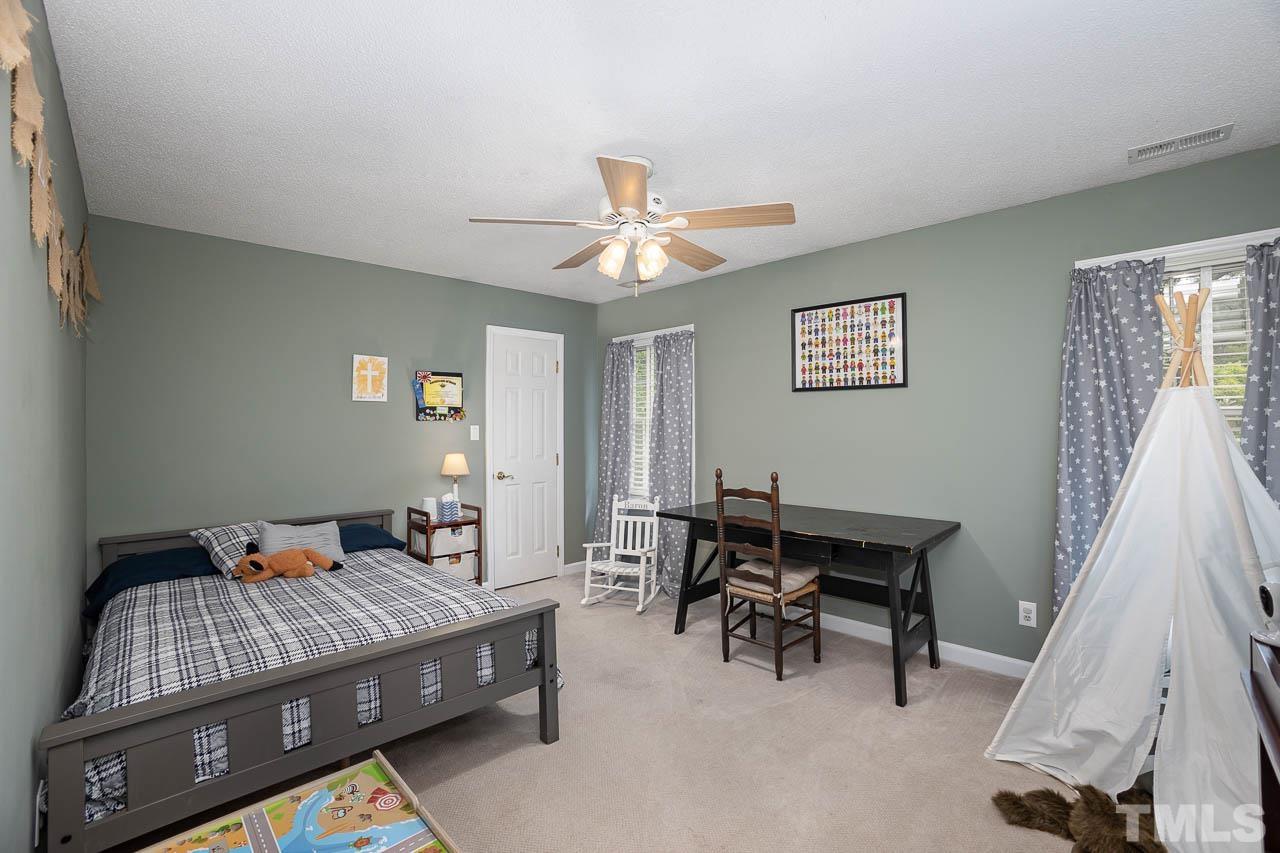 2009 Ryerson Drive Garner, NC 27529 - Photo 24 of 27 a bedroom with furniture and a window