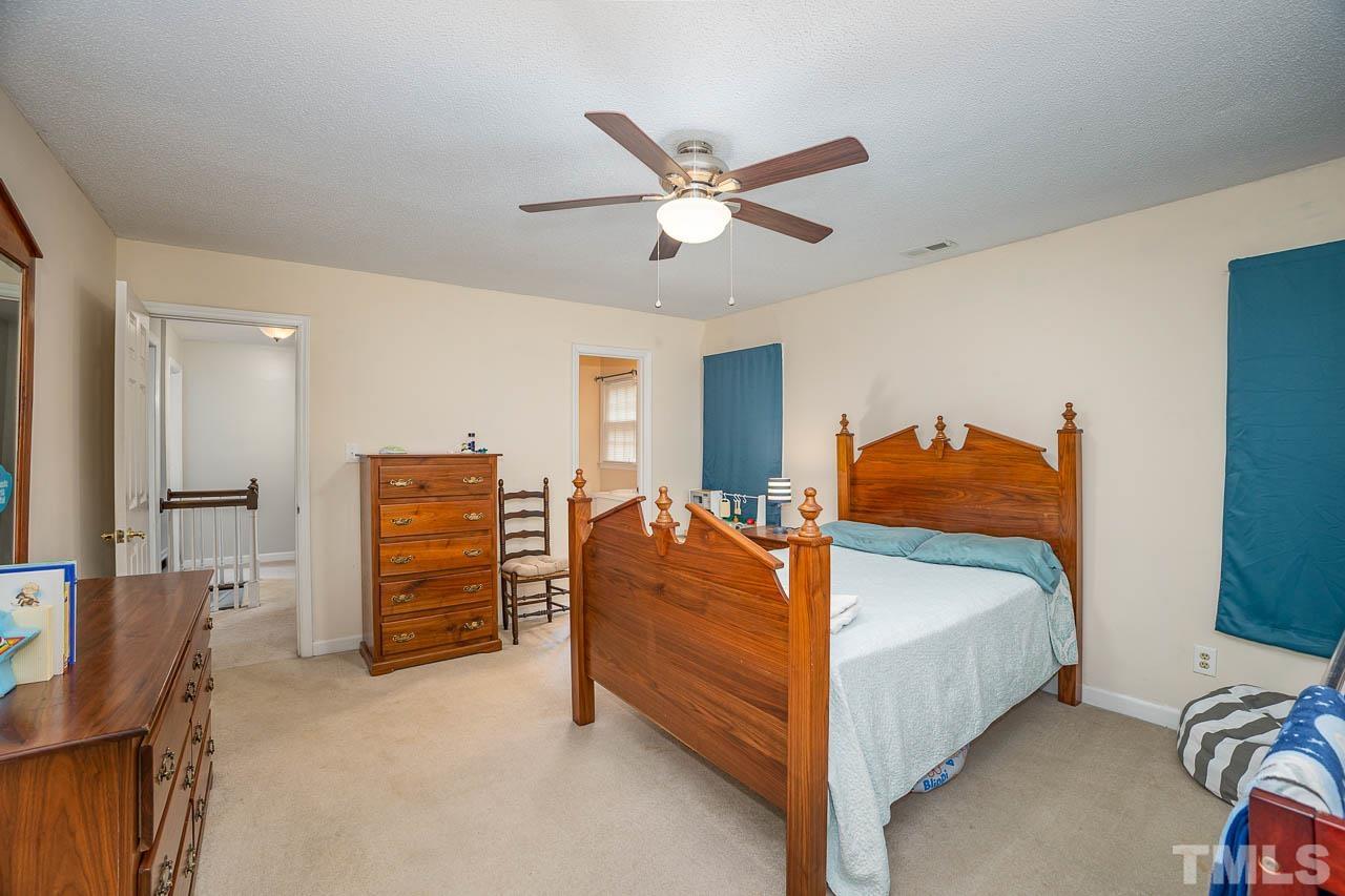 2009 Ryerson Drive Garner, NC 27529 - Photo 26 of 27 a bed room with a bed and a ceiling fan