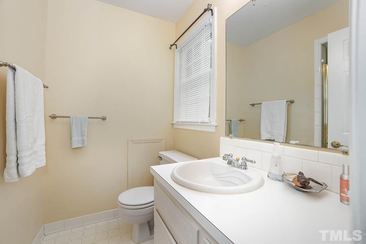 2009 Ryerson Drive Garner, NC 27529 - Photo 27 of 27 a bathroom with a sink toilet and mirror