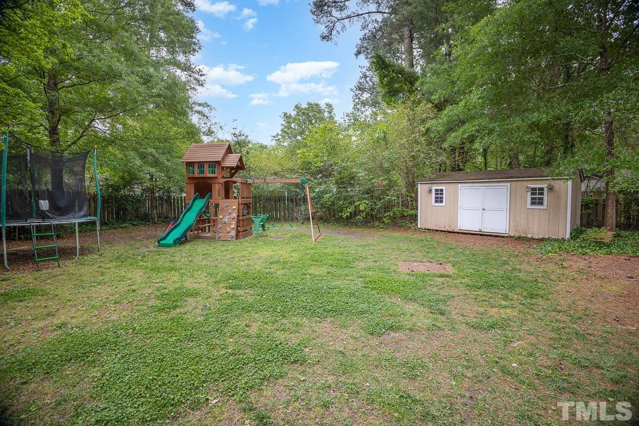 2009 Ryerson Drive Garner, NC 27529 - Photo 6 of 27 a view of a house with a backyard and a slide
