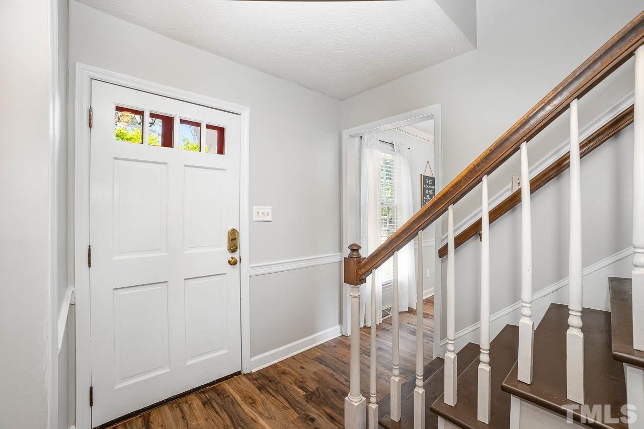2009 Ryerson Drive Garner, NC 27529 - Photo 7 of 27 a view of entryway with wooden floor and stairs