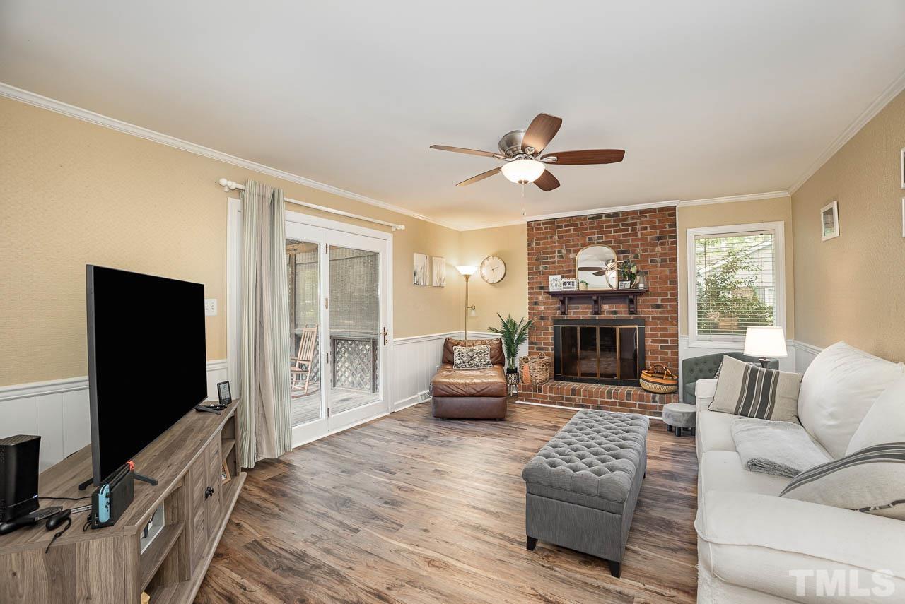 2009 Ryerson Drive Garner, NC 27529 - Photo 10 of 27 a living room with furniture a fireplace and a flat screen tv