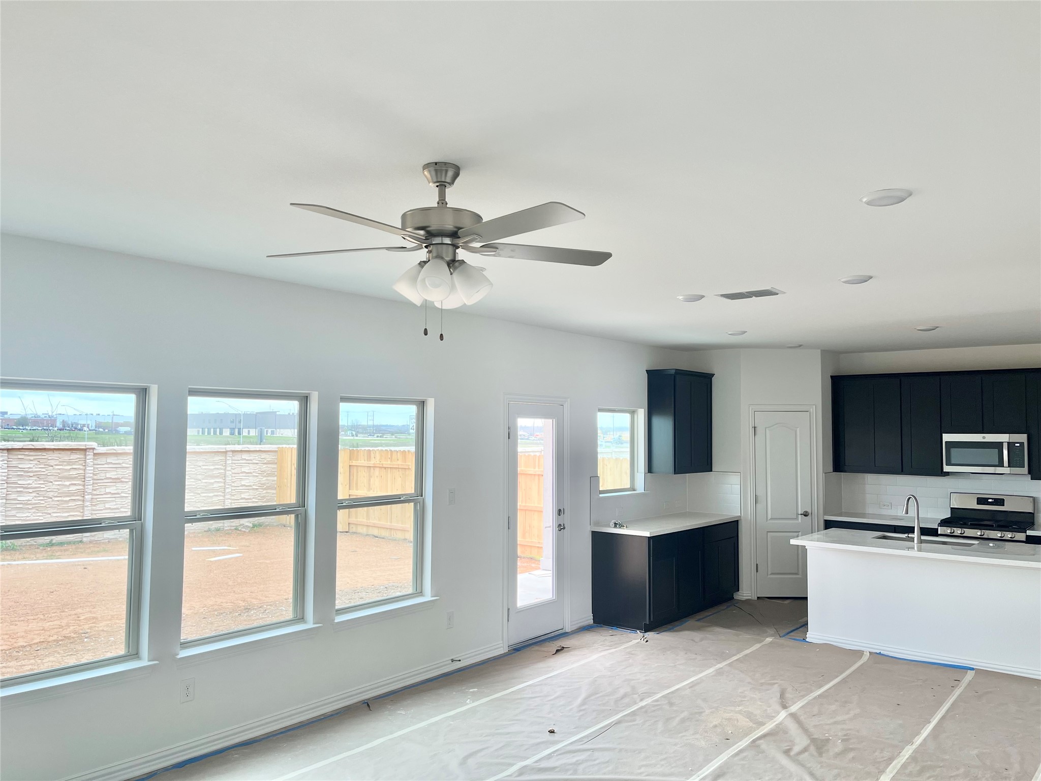 25620 Wheat Seed Lane Elgin, TX 78621 - Photo 12 of 14 a large white kitchen with a large window cabinets and appliances