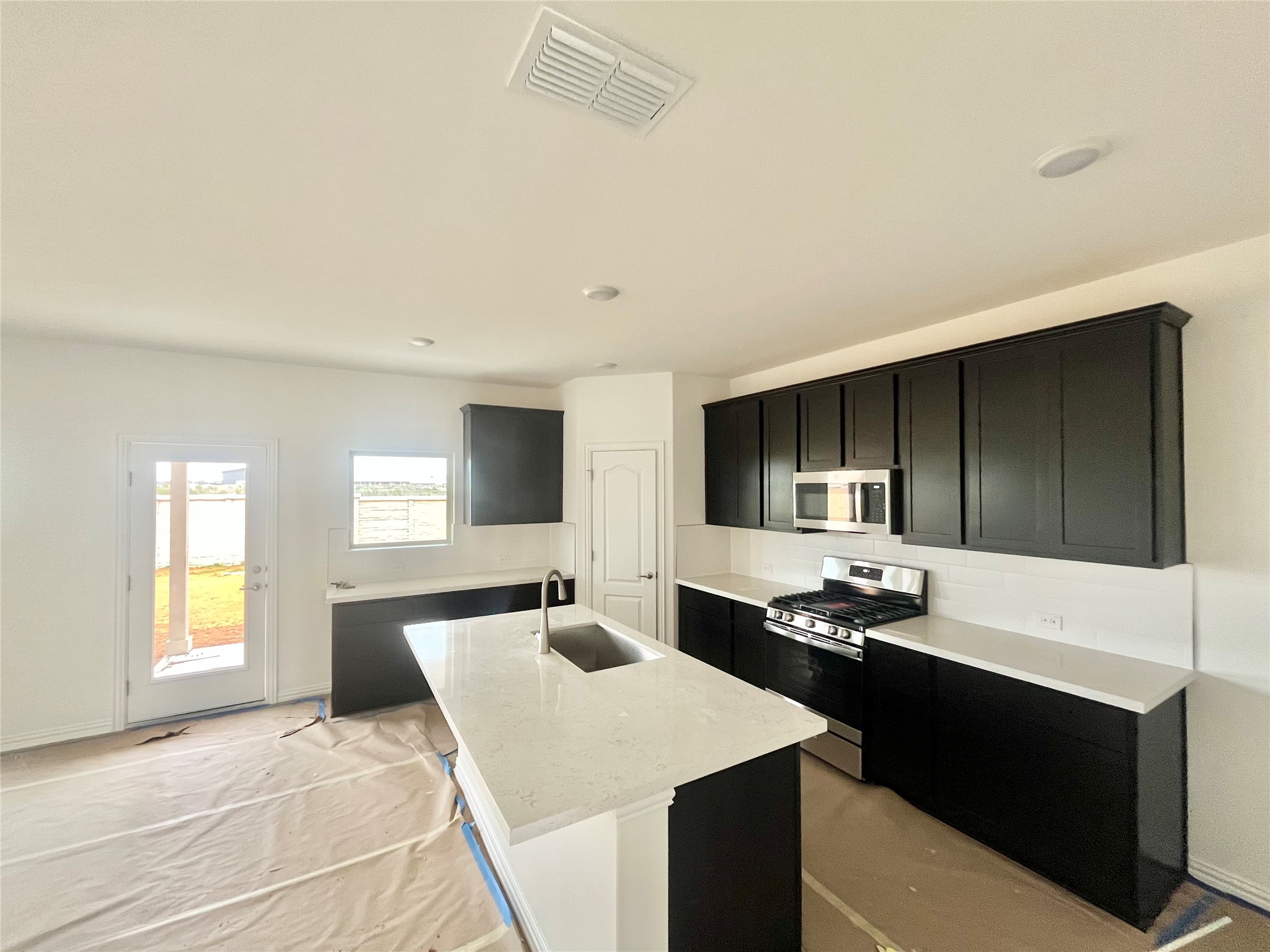 25620 Wheat Seed Lane Elgin, TX 78621 - Photo 2 of 14 a kitchen that has a sink and a stove in it