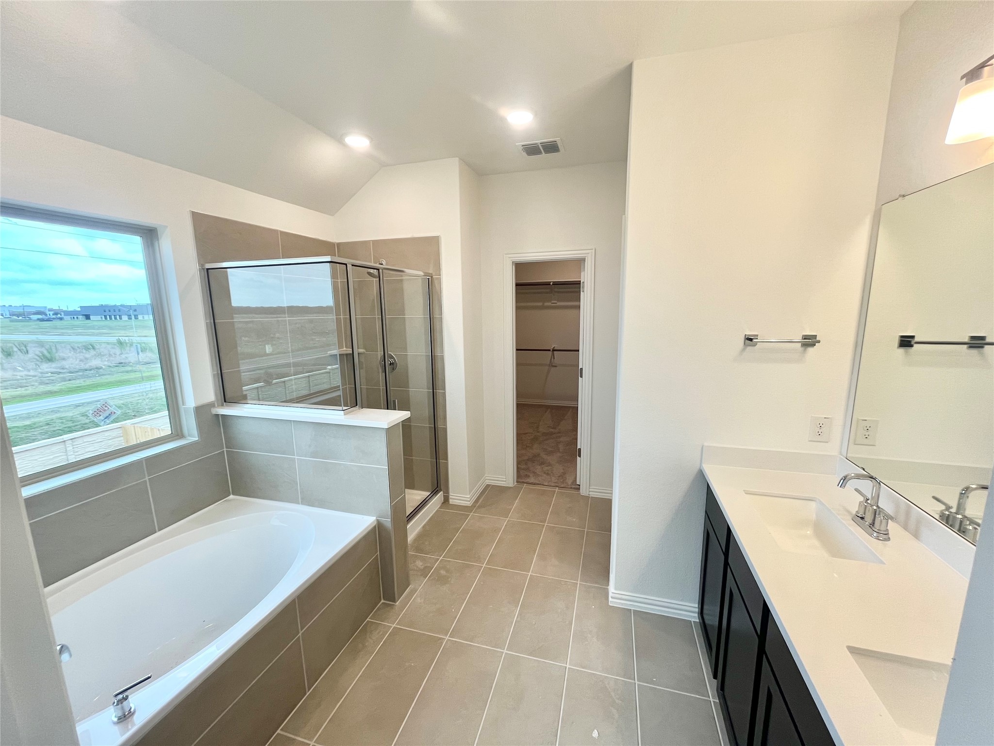 25620 Wheat Seed Lane Elgin, TX 78621 - Photo 7 of 14 a bathroom with a tub sink and mirror