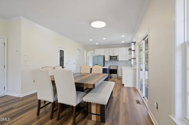 a view of a dining room with furniture and wooden floor
