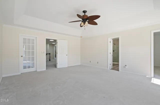 a view of empty room with ceiling fan