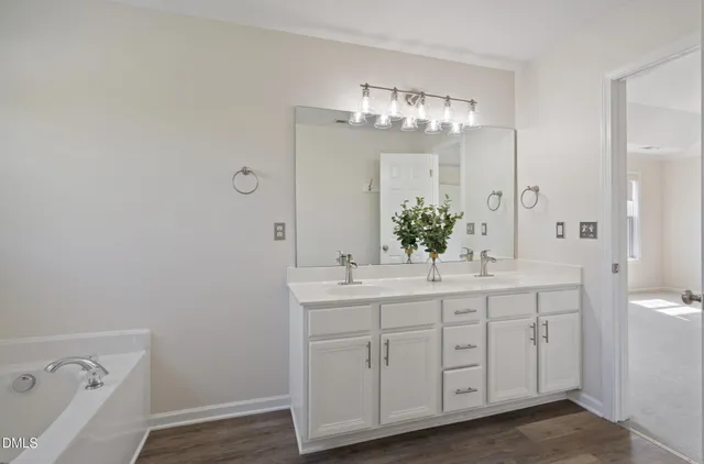 a spacious bathroom with a double vanity sink and a mirror