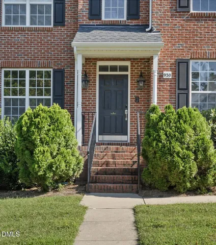 front view of a brick house with a yard